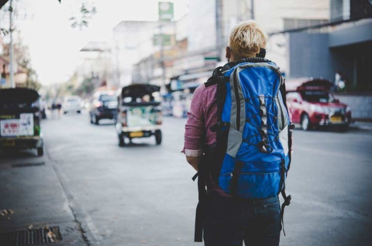 guy walking with a backpack